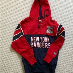 a new york rangers hoodie laying on the floor