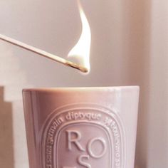 a lit matchstick sticking out of a cup with the word ro in front of it