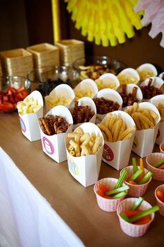 there are many small cups that have food in them on the table with other items