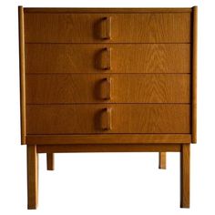 the chest of drawers is made from wood and has five drawers on one side, with three