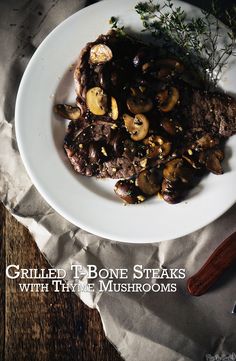 grilled bone steaks with thyme mushrooms on a white plate