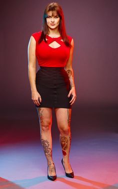 a woman with tattoos on her arms and legs poses for the camera in front of a purple background