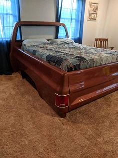 a bed sitting in the middle of a living room