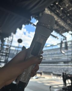 a person holding a microphone in their hand