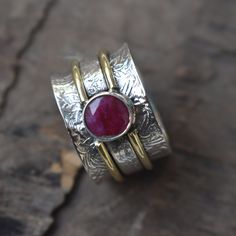 Item Name :- Natural Ruby Spinner Ring 925 Sterling Silver Ring  Metal :-   Solid 925 Sterling Silver  Quantity :- 1 Piece Gemstone :- Ruby  Weight :- 12.32 grm  Stone Shape :- Round Stone Color :- Red Ring Size :- All Size Available Band Color :- Silver  Style :- Spinner Ring Pearl  benefits Gemstone :-  Pearl stone bestows the powers of Moon (Chandra) on its wearer and brings him peace, confidence, courage and calmness.Pearl strengthens Moon (Chandra) in the wearer's horoscope. ... Pearl stone Handmade Sterling Silver Ruby Ring In Open Ring Style, Handmade Ruby Open Ring In Sterling Silver, Handmade Sterling Silver Ruby Ring, Open Style, Handmade Sterling Silver Ruby Ring With Open Design, Handmade Sterling Silver Open Ruby Ring, Pearl Benefits, Fluorite Ring, Hematite Jewelry, Two Tone Ring