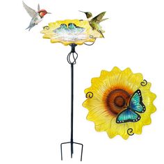 two birds are flying over a sunflower and a bird feeder