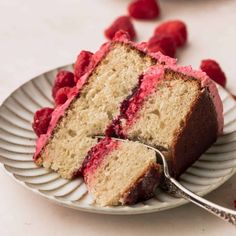 a slice of cake with raspberry filling on a plate