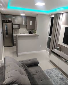 a living room filled with furniture and a flat screen tv on top of a wall