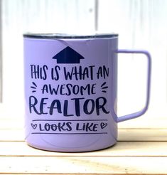 this is what an awesome realtor looks like on a purple coffee mug sitting on a wooden table