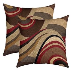 two brown and red pillows sitting next to each other