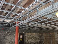 the inside of a building that is under construction with metal beams and lights hanging from it's ceiling