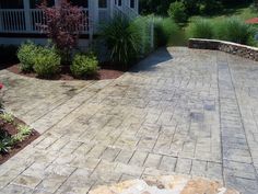 a brick patio in front of a house