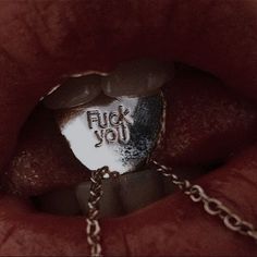 a close up of a person's mouth with a chain around it and the word flud you on it