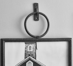 a black and white photo of a house with a key ring hanging from it's side