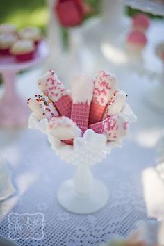 a table topped with lots of desserts covered in frosting and sprinkles