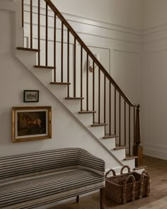 a room with a bench, basket and pictures on the wall