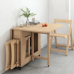 a wooden table with two chairs next to it and a potted plant on top