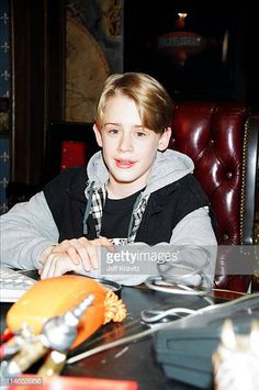 a young boy is sitting at a table