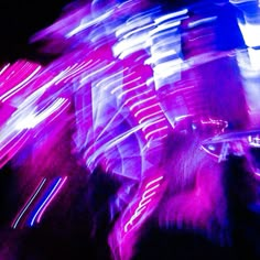 blurry photograph of people walking in the street at night