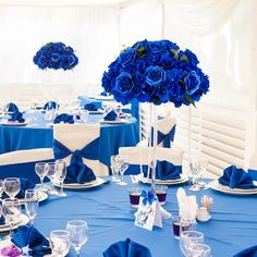 a table set with blue flowers and place settings