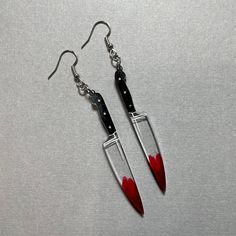 *Please read before purchasing!* Large knife earrings made with resin and hand painted details. Length of the knife portion is approximately 2.5 inches long. Last photo compares the size of the mini and large knives. All earrings are made with hypoallergenic (nickel free) silver findings and have fish hook earring wires.  Other important information: - resin pieces naturally have micro bubbles or spots where air bubbles have popped - no two resin pieces are alike / restocks of these pairs will be different than the photos - FINAL PRODUCT MAY DIFFERENTIATE IN COLOR FROM PHOTOS Resin Knife, Knife Earrings, Weird Jewelry, Edgy Jewelry, Earring Wires, Fish Hook Earrings, Funky Jewelry, Halloween Earrings, Fancy Jewelry