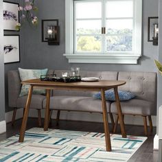 a living room with a couch and table in front of a window on the wall