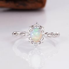 Gorgeous vintage inspired Australian opal ring ✧ Sterling silver (925) or 14K Gold or 14K Rose gold ✧ Accented with natural quartz diamonds This gorgeous, timeless ring features a stunning Australian opal and natural crystals. ✧ Stone: Natural Gemstone  ✧ Shape: Oval ✧ Carat Weight: 0.53ct. (approx.) ✧ Gemstone Origin: Australia  ✧ Sizes 2.75-12.25 ✧ This ring set will arrive ready to gift in a Kherish Box. ✧ Due to the nature of the handmade process, each piece may slightly vary in color, size, Silver And Opal Ring, Delicate Sterling Silver Opal Ring For Anniversary, Elegant Ethiopian Opal Ring For Anniversary, Elegant Ethiopian Opal Ring, Delicate Opal Ring - Perfect Gift, Classic Ethiopian Opal Ring As A Gift, Heirloom White Gold Opal Ring As A Gift, Heirloom White Gold Opal Ring Gift, Silver Opal Gemstone Ring In 14k Gold