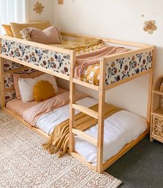 a bunk bed sitting in the corner of a room next to a dresser and window