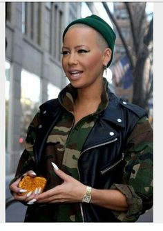 a woman in camouflage holding food on the street