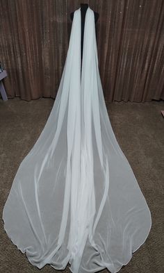 the back of a white wedding veil on display