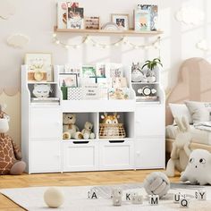 a child's room with stuffed animals and toys on the floor in front of a white bookcase