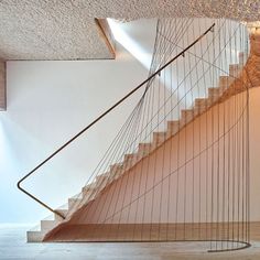 a spiral staircase in an empty room with white walls