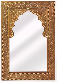 an intricately carved wooden mirror with gold trimmings on the edges and sides