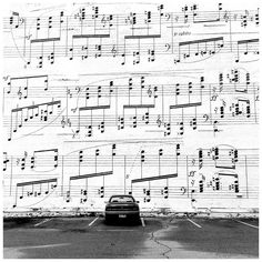 a car parked in front of a sheet music wall