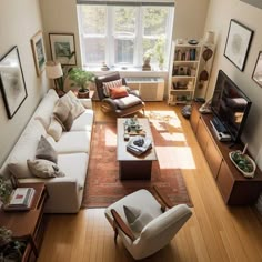 an overhead view of a living room with couches, coffee table, and television