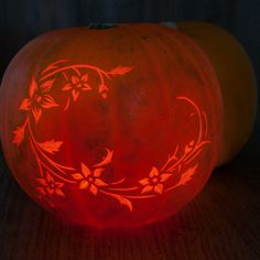 a carved pumpkin sitting on top of a wooden table