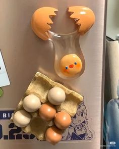 an egg and some other items are on the refrigerator magnets that look like they have been broken