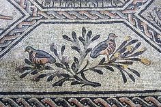 an old mosaic with birds and flowers on it