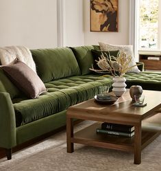 a living room with a green couch and coffee table