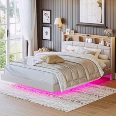 a bed with pink lights on it in a bedroom next to a window and rug