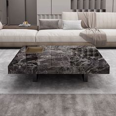 a marble coffee table sitting on top of a gray carpeted floor next to a couch