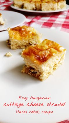 two pieces of cottage cheese strudel on a white plate with red checkered tablecloth