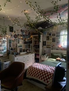 a bedroom with lots of lights hanging from the ceiling and pictures on the wall above it