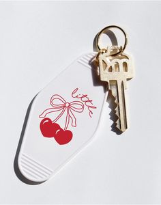 a keychain with a cherries design on it