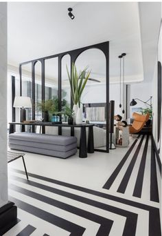 a living room with black and white stripes on the floor