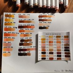 several different shades of paint sitting on top of a paper