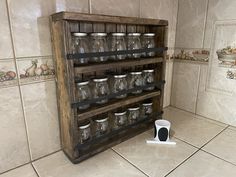 an old wooden shelf with glass jars on it