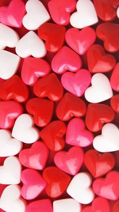 red and white heart shaped candies are arranged in the shape of hearts on top of each other