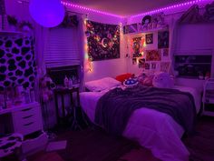 a bedroom with purple lights and decorations on the walls