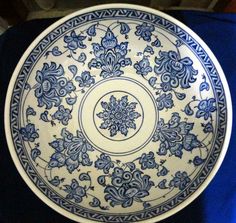 a blue and white plate sitting on top of a table